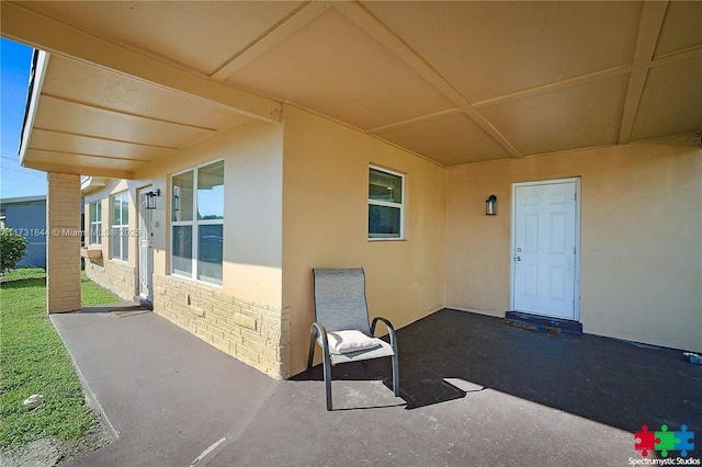 property entrance featuring a patio area