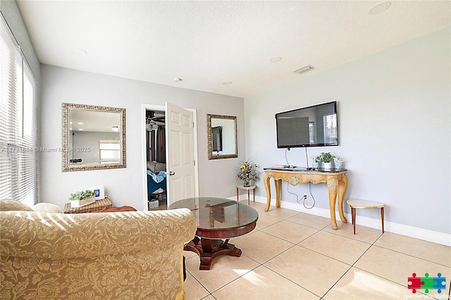 living room with light tile patterned flooring and a textured ceiling