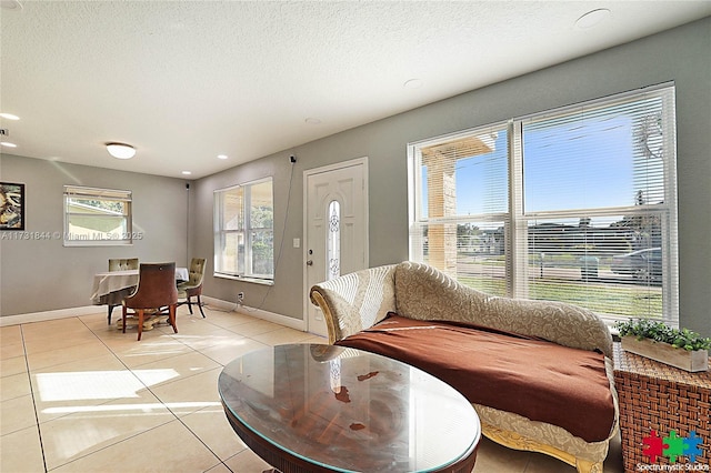 living room with light tile patterned flooring and a textured ceiling