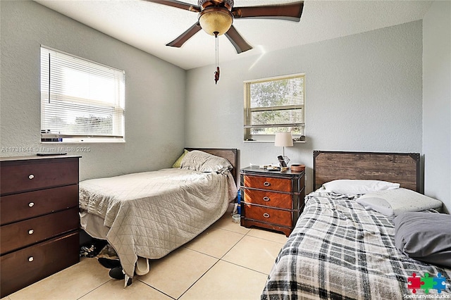 bedroom with ceiling fan and light tile patterned floors