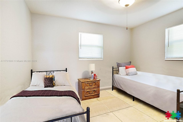 bedroom featuring multiple windows and light tile patterned floors