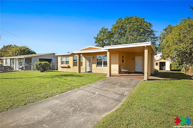 ranch-style home with a carport and a front lawn