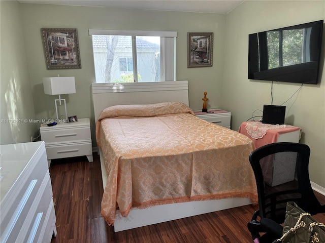 bedroom with dark wood-type flooring