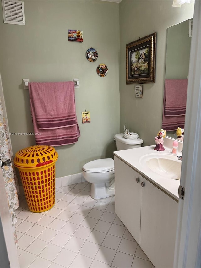 bathroom featuring vanity, tile patterned floors, and toilet