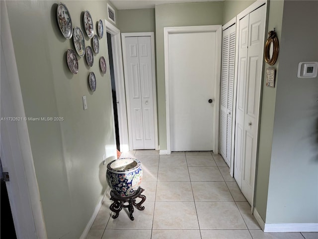 hall with light tile patterned floors