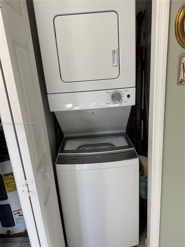 clothes washing area with stacked washer and clothes dryer