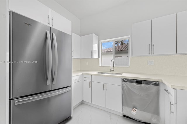 kitchen featuring white cabinetry, sink, and appliances with stainless steel finishes