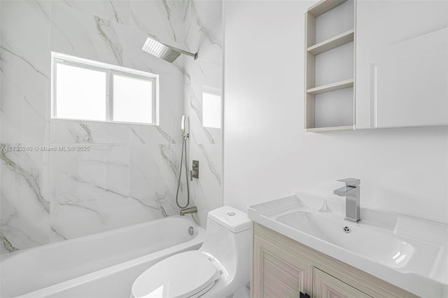 full bathroom featuring vanity, tiled shower / bath, and toilet