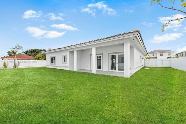 rear view of house with a yard