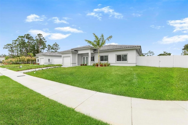 mediterranean / spanish house with a garage and a front yard