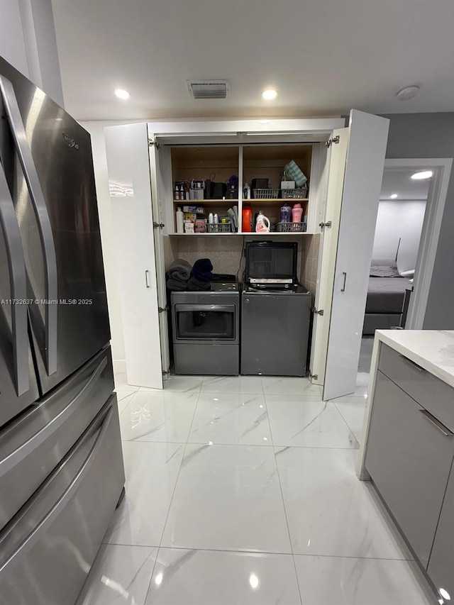 pantry with washer and clothes dryer