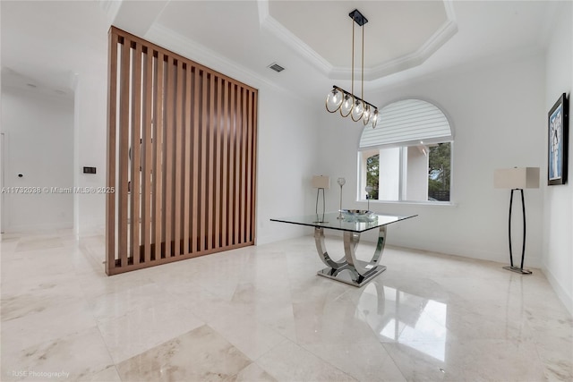 unfurnished dining area featuring a raised ceiling and ornamental molding