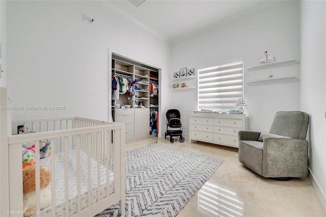 bedroom with ornamental molding, a nursery area, and a closet