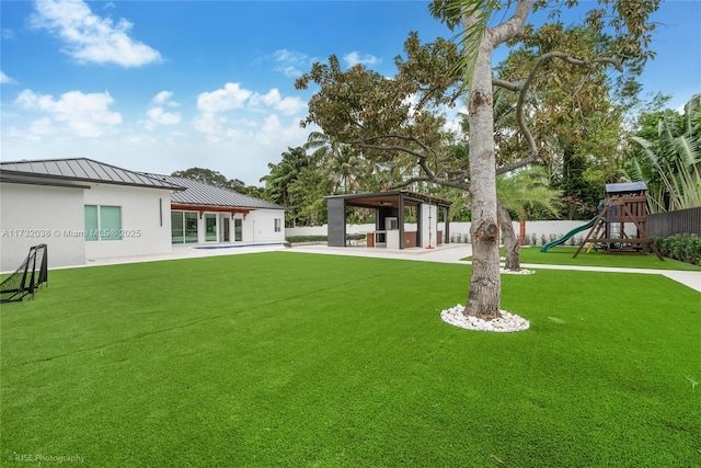 view of yard featuring a gazebo and a playground