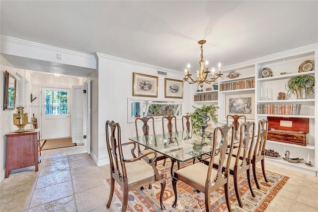 dining space with ornamental molding and a chandelier