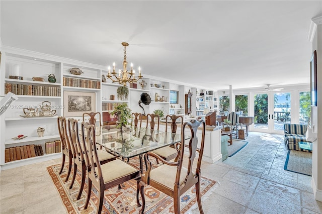 dining room with built in shelves, ornamental molding, and ceiling fan with notable chandelier