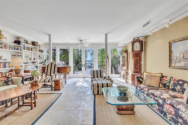 sunroom / solarium featuring french doors, track lighting, and ceiling fan