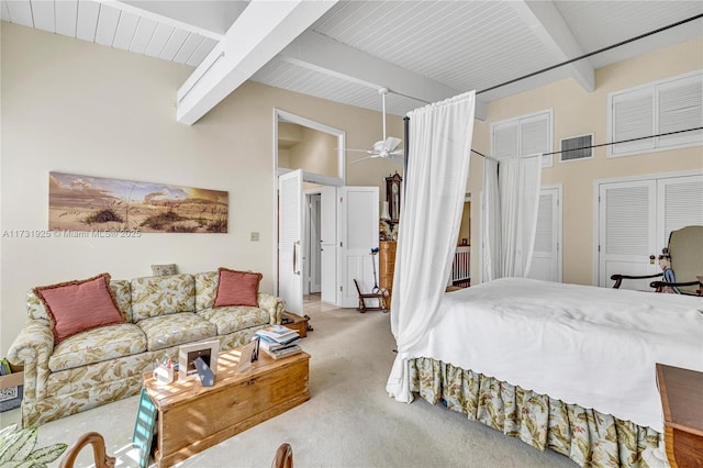 bedroom featuring carpet flooring and vaulted ceiling with beams