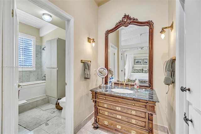 full bathroom with tiled shower / bath combo, vanity, and toilet