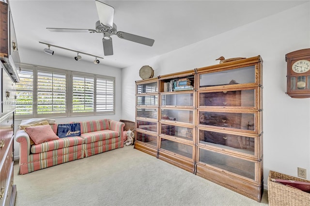 living room with rail lighting, carpet, and ceiling fan