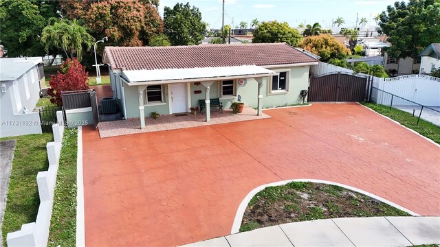 rear view of property featuring central AC