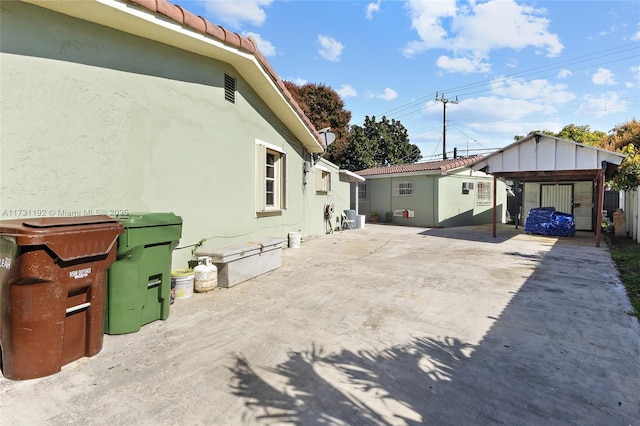 exterior space featuring a tile roof and stucco siding