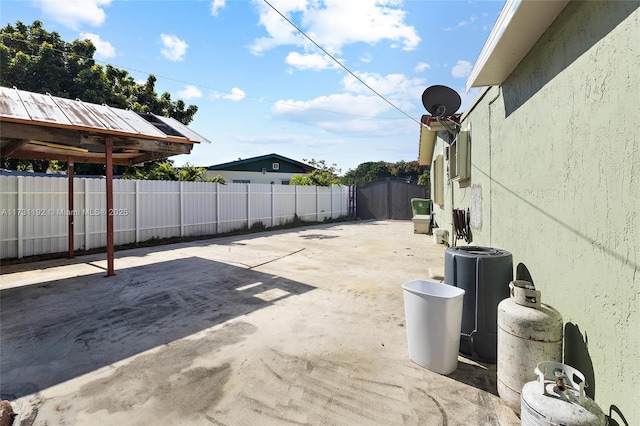 view of patio / terrace featuring a fenced backyard and a shed