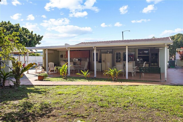 rear view of house with a yard and a patio