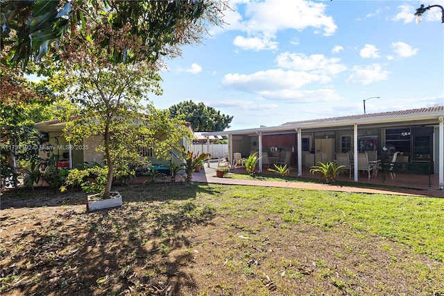 view of yard featuring a patio and fence