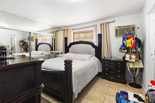 tiled bedroom featuring multiple windows and a wall mounted AC