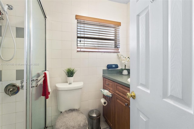 full bath featuring toilet, a stall shower, tile walls, and vanity