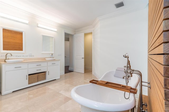 bathroom featuring a bathing tub, vanity, and crown molding