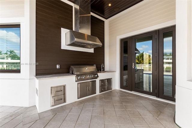 view of patio with area for grilling, a grill, and sink