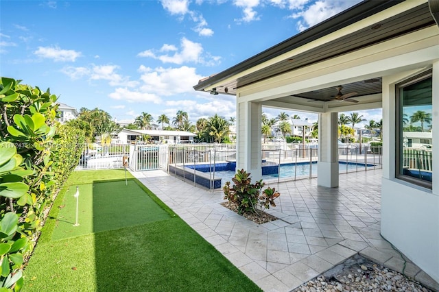 view of patio / terrace featuring a fenced in pool and ceiling fan