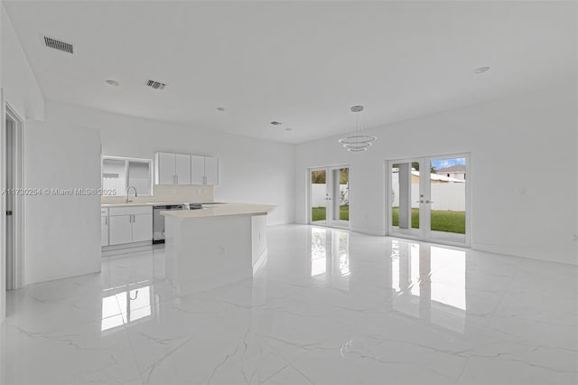 unfurnished living room featuring sink and french doors