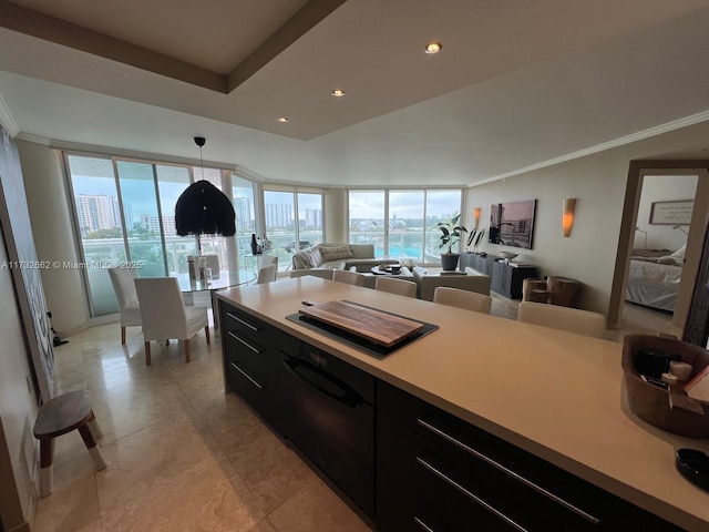 kitchen featuring light tile patterned flooring, ornamental molding, floor to ceiling windows, and decorative light fixtures