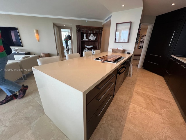 kitchen with black gas stovetop, a kitchen island, ornamental molding, and a kitchen breakfast bar