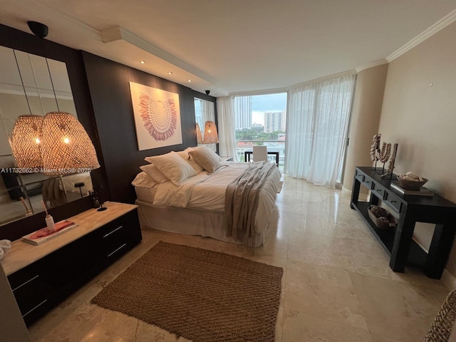 bedroom with crown molding and a wall of windows