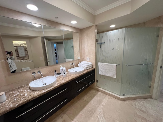 bathroom with an enclosed shower, vanity, crown molding, and decorative backsplash