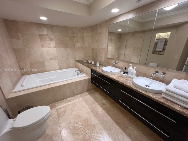 bathroom featuring tile walls, vanity, a relaxing tiled tub, toilet, and crown molding