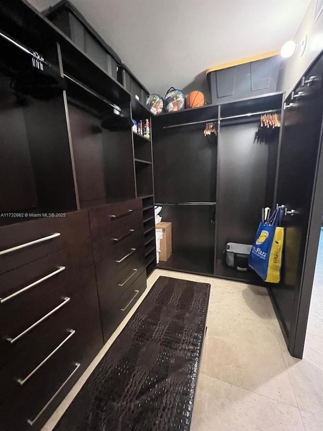 spacious closet featuring light tile patterned flooring