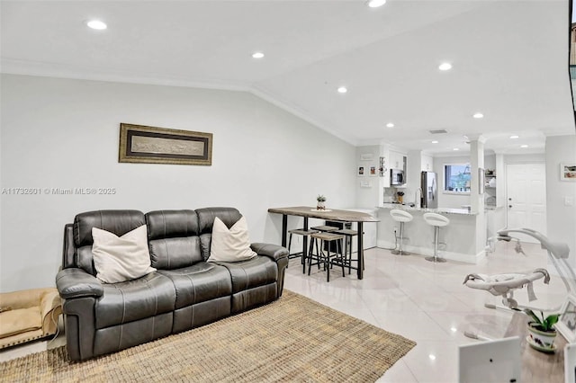 tiled living room with sink, crown molding, vaulted ceiling, and decorative columns