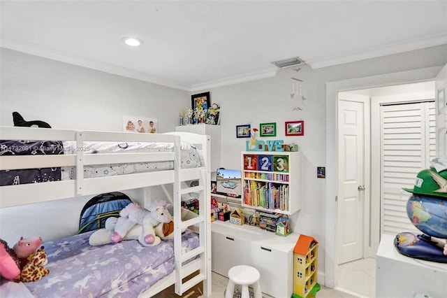 bedroom featuring tile patterned flooring and crown molding