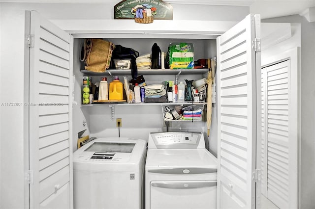 clothes washing area with washing machine and clothes dryer