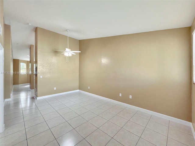 tiled spare room with ceiling fan