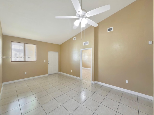 spare room with lofted ceiling, light tile patterned floors, and ceiling fan