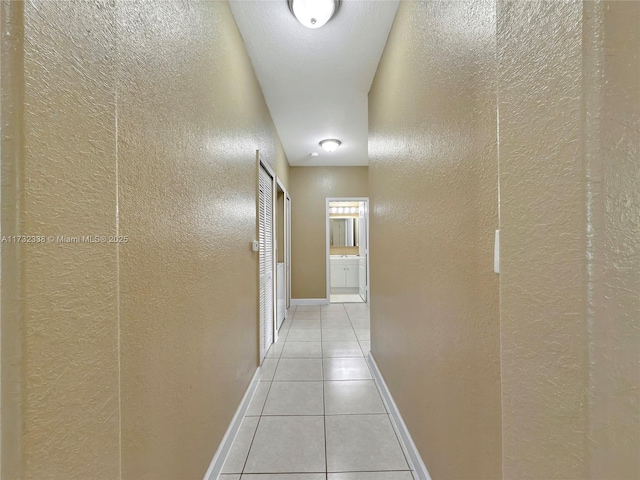 corridor with light tile patterned floors