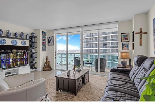 living room featuring expansive windows and a water view