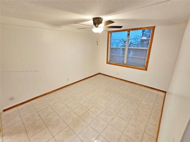 unfurnished room featuring a ceiling fan, a textured ceiling, and baseboards