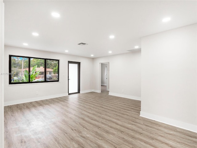 unfurnished room with light wood-type flooring